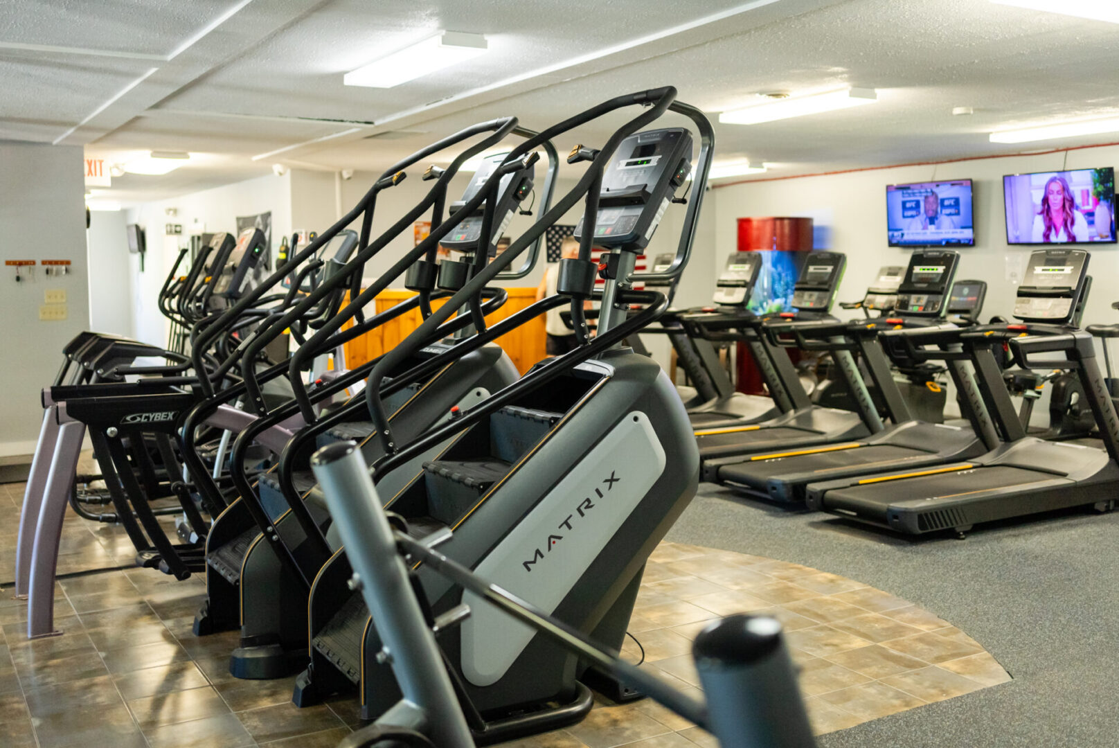 A row of exercise equipment in a gym.