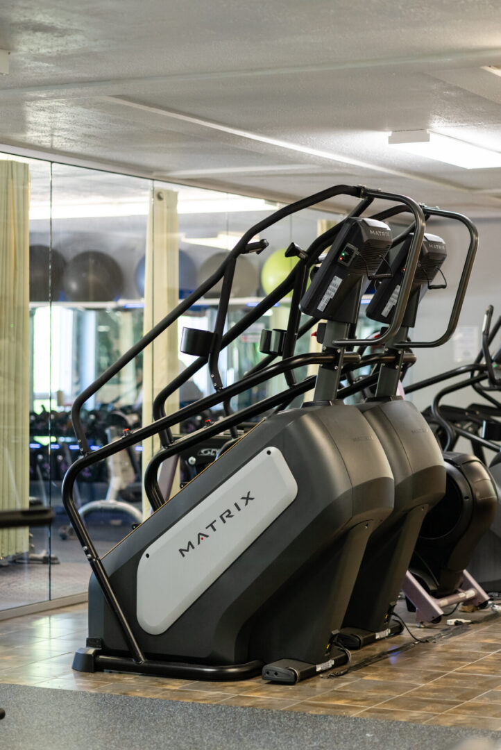 A gym with many different machines in it