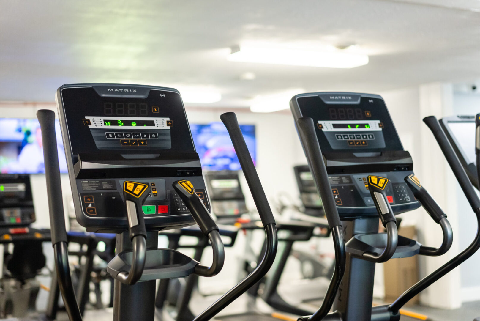 A row of exercise machines in a gym.