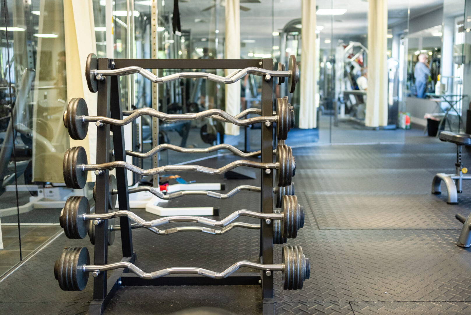 A gym with many different types of dumbbells.