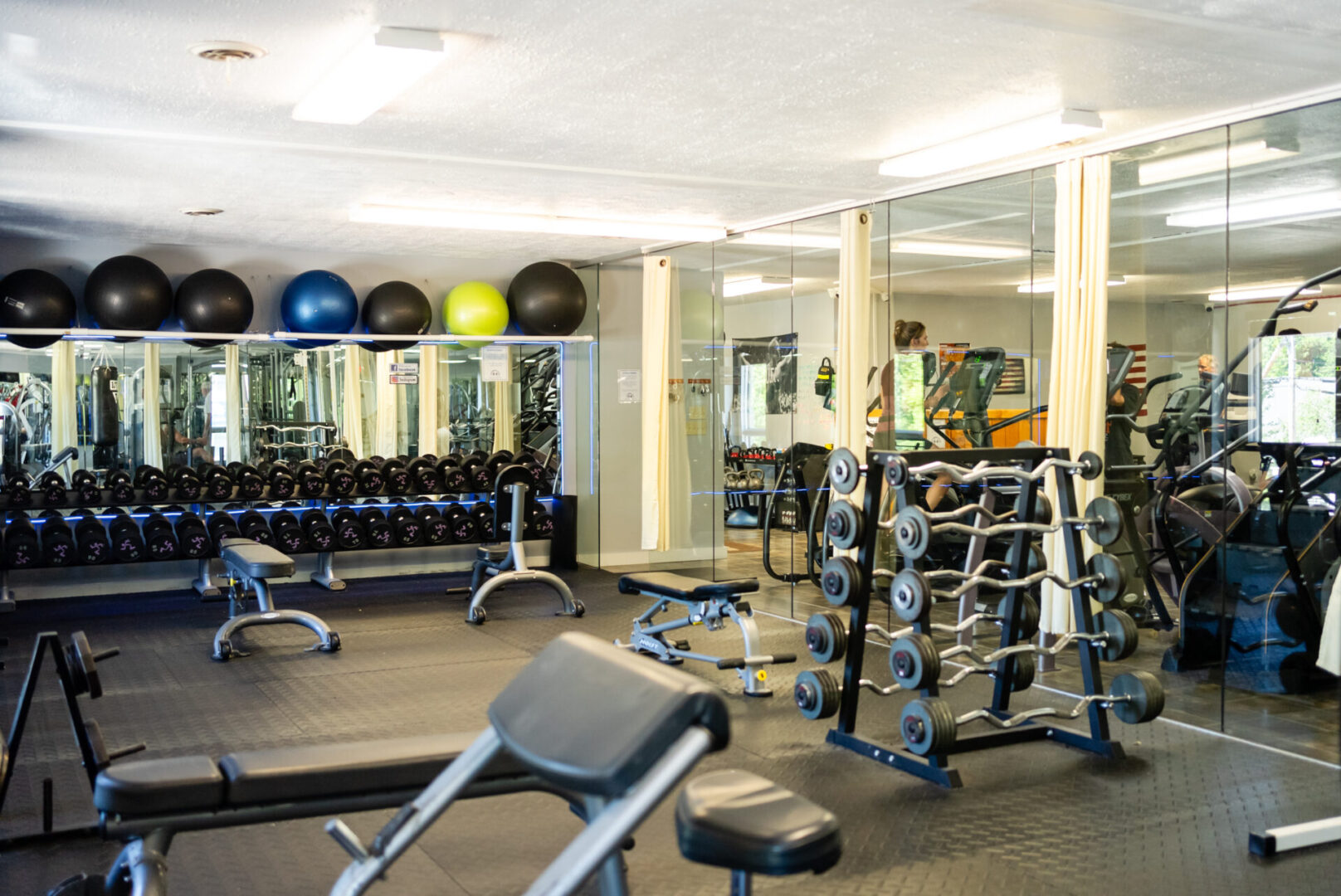 A gym with many different types of exercise equipment.