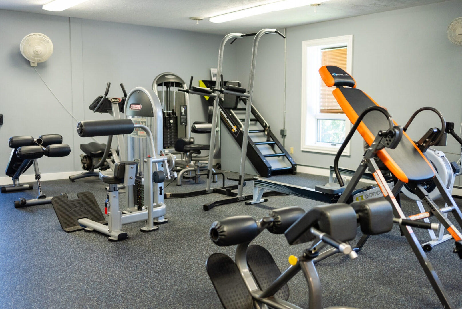 A gym with many different machines and equipment.