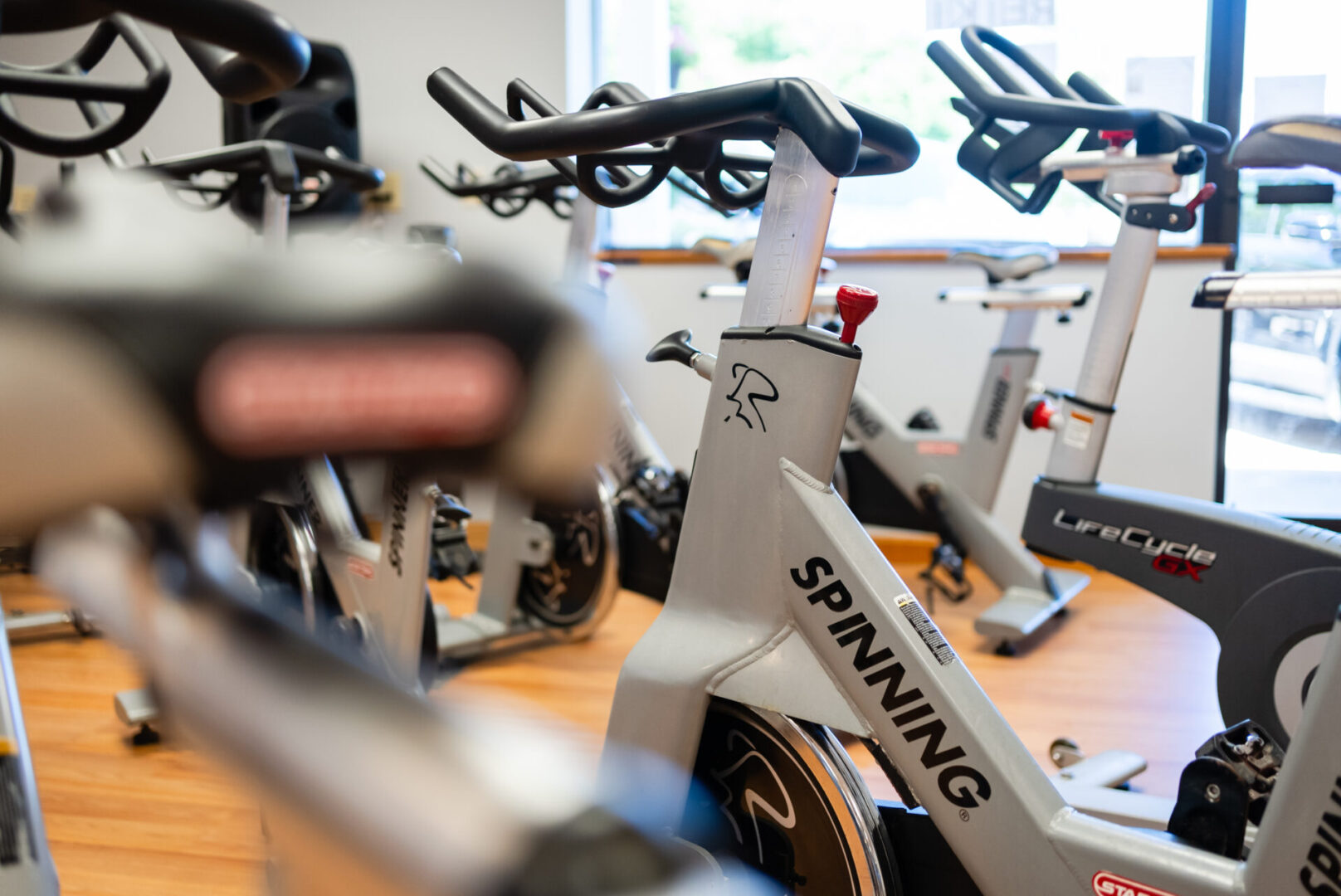 A group of exercise bikes in a room.